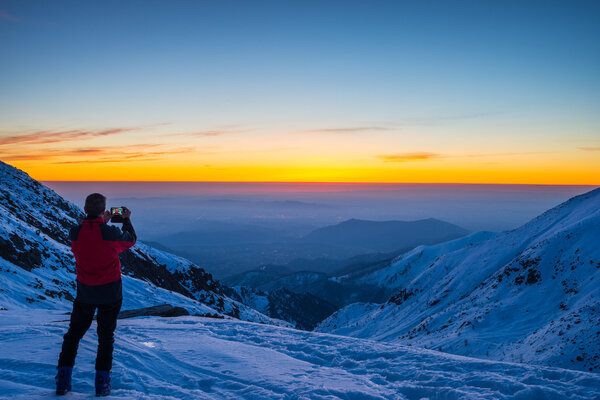 Alpinist taking selfie at twilight