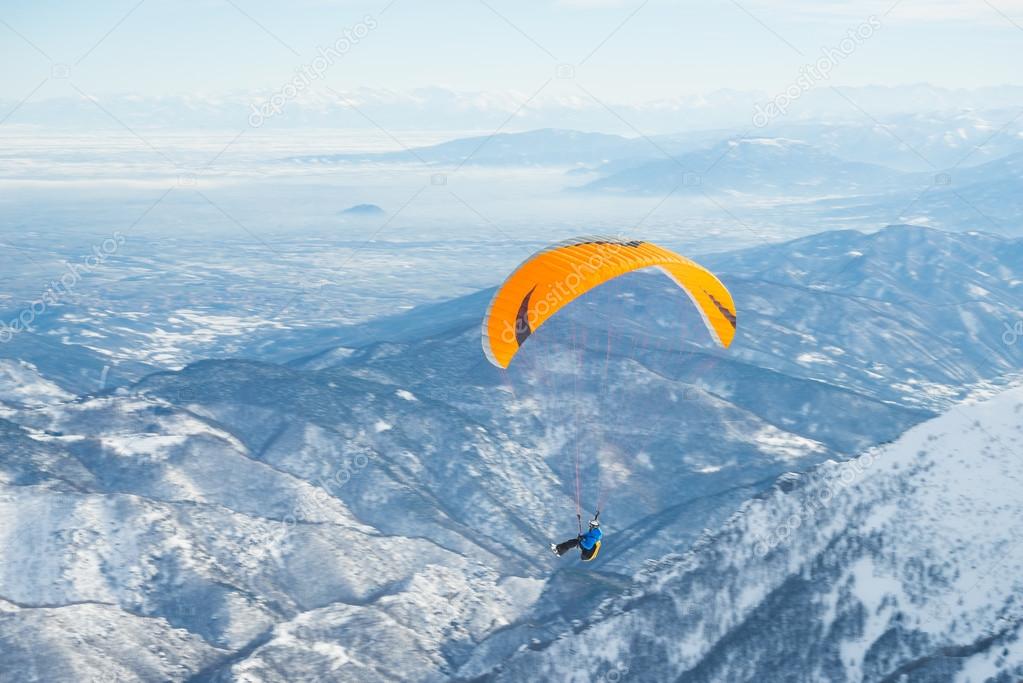 Paraglider flying over the Alps