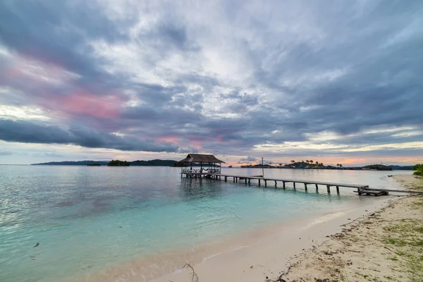 Seascape and cloudscape with jetty at dusk — Stok Foto