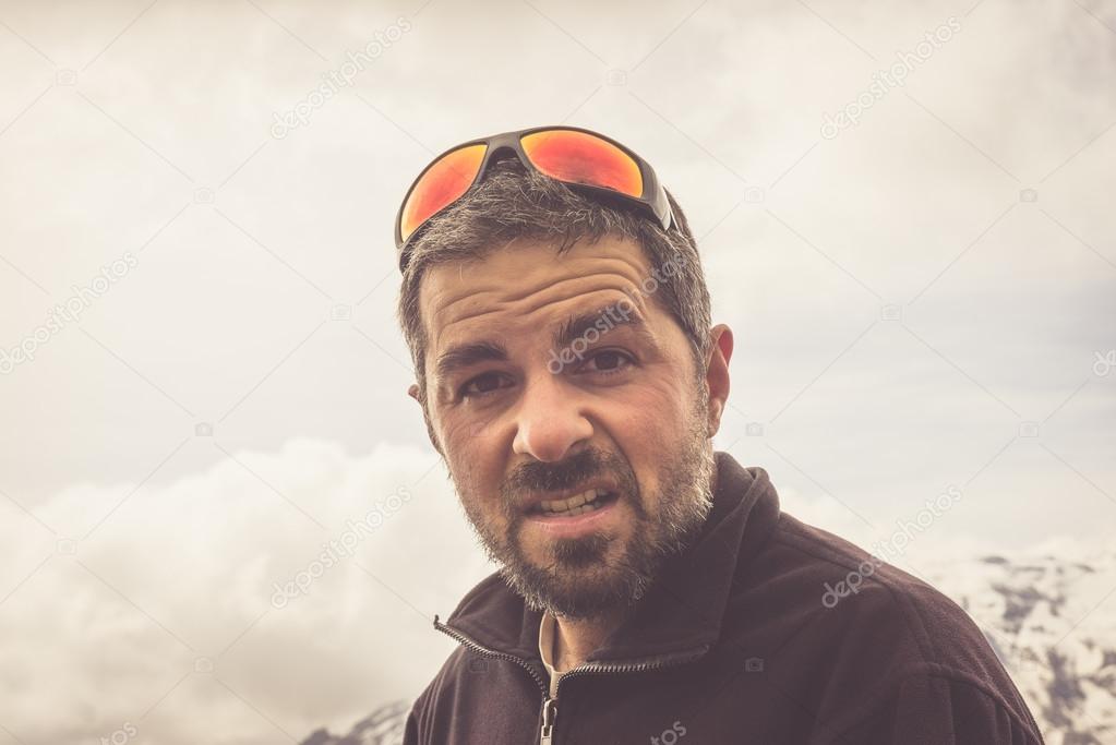 Tired hiker with dramatic sky, toned image