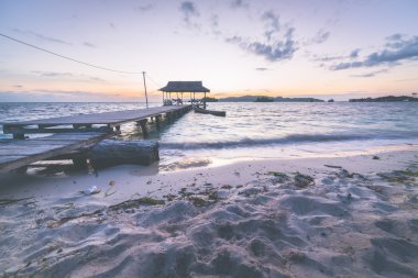 Tourist beach resort at dawn, marsala toned image