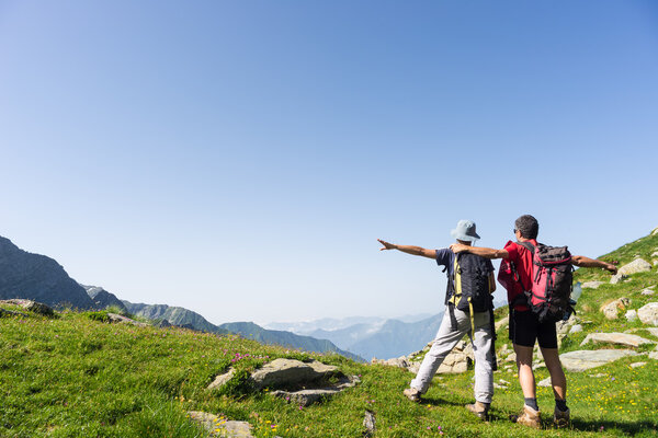 Couple watching panorama high up in the Alps