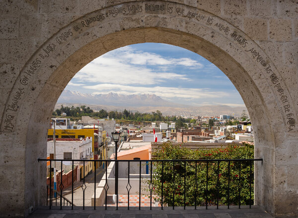 Volanic stone arch and cityscape, Arequipa, Peru