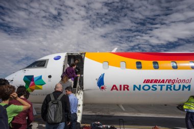 Travelers boarding Iberia Regional Air Nostrum flight clipart