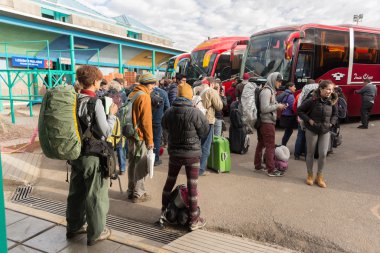 Travelers waiting for boarding autobus in Puno, Peru