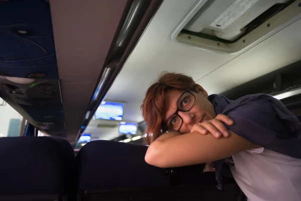 Female traveler inside autobus looking at camera