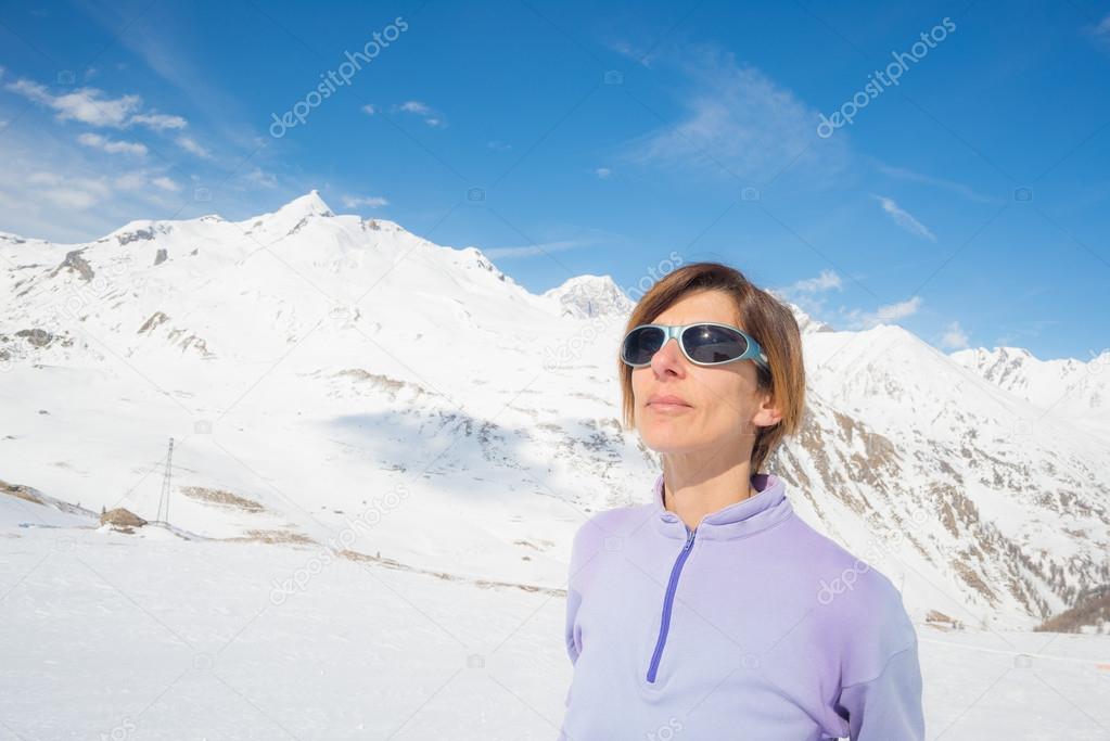 Female alpinist watching the sun