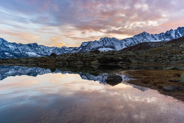 Высотное альпийское озеро, отражения на закате — стоковое фото