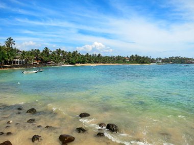 Mirissa bay with rocks, greens and ocean waves, Sri Lanka