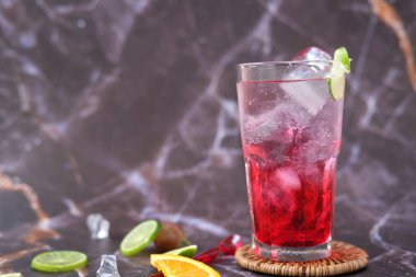 summer drink. cocktail with ice cubes and lime, copy space, selective focus.