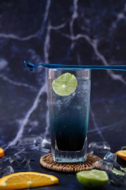 summer drink. cocktail with ice cubes and lime, copy space, selective focus.