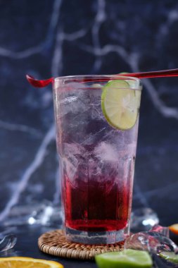 summer drink. cocktail with ice cubes and lime, copy space, selective focus.