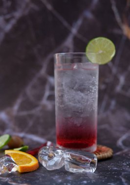 summer drink. cocktail with ice cubes and lime, copy space, selective focus.