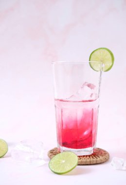 summer drink. cocktail with ice cubes and lime, copy space, selective focus.