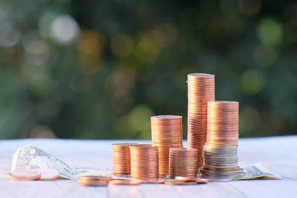 Stacks of gold money coin on black background and concept saving money, business growth strategy of money concept, advertising coins of finance and banking