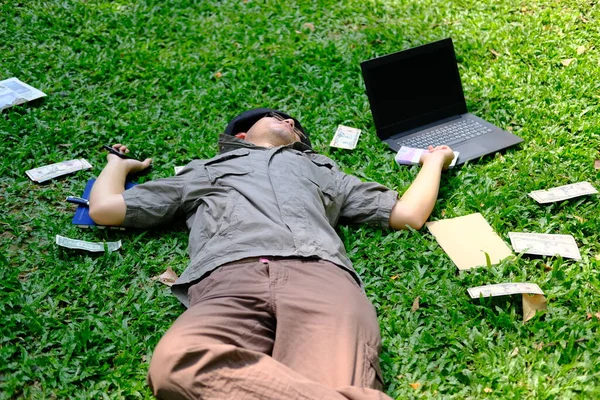 Person using laptop computer in garden