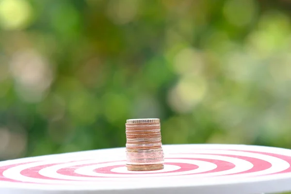 Coins and dart board with target and business growth concept business plan successful