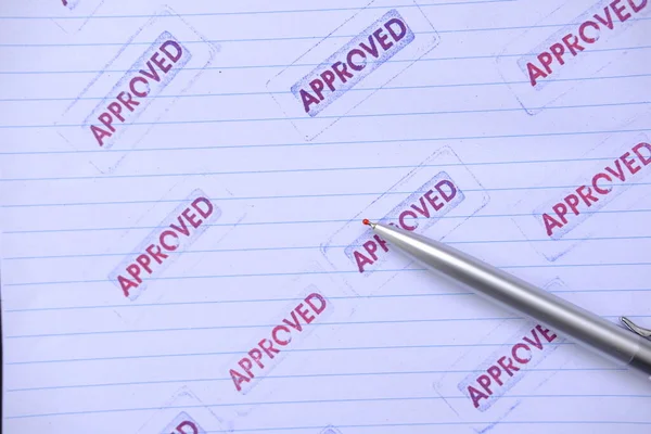 stamp with approved word on white paper background