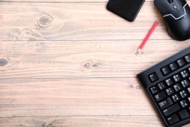 Ahşap arka planda klavyesi ve kalemi olan ofis masası