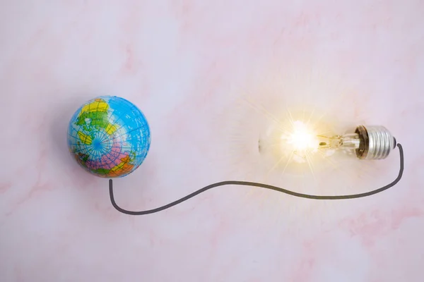 light bulb and a globe model, energy concept