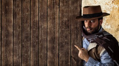 Gunfighter pointing on wooden table. clipart