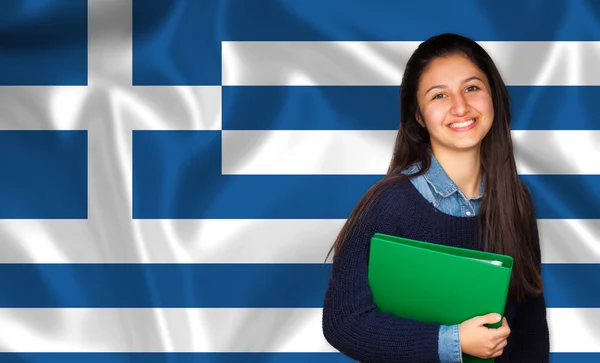 Teen student smiling over Greek flag