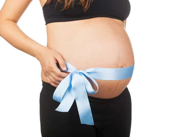 Pregnant woman with pink ribbon around her belly. — Stock Photo, Image