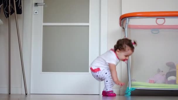 1歳の少女が家の周りを這い回る 這うことは精神運動発達のための準備運動です歩く方法を学ぶために — ストック動画