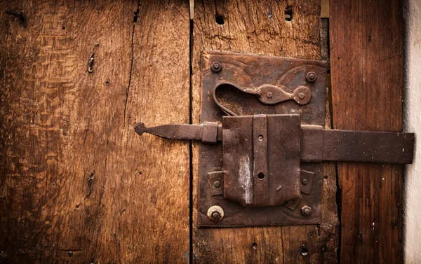Old lock of a wooden door's Trullo in Alberobello. Royalty Free Stock Photos