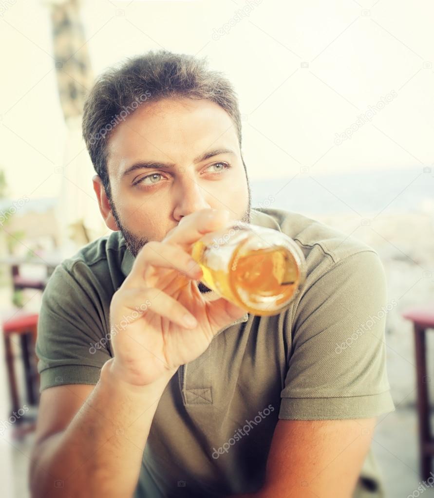 Young man drinking beer