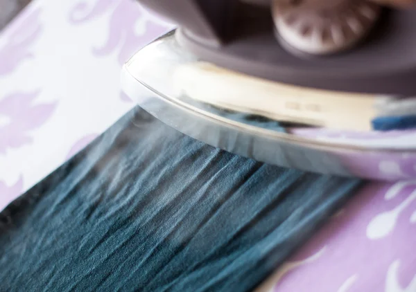 Close up of an iron running with steam — Stock Photo, Image