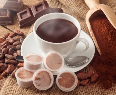 Cup of hot chocolate with pods. clipart