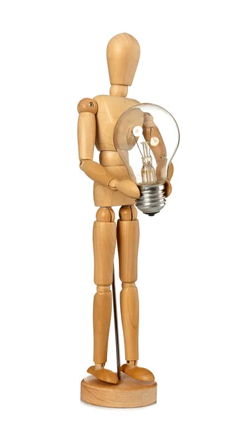 Wooden dummy that maintains a light bulb in hand — Stock Photo, Image