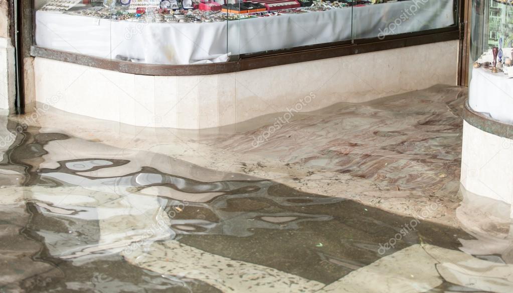 Entrance of a store during high water in Venice.