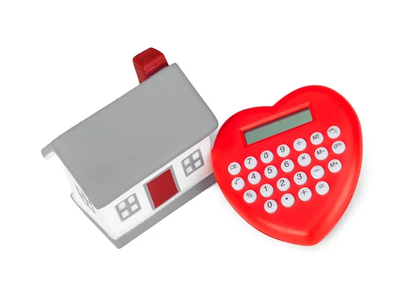 Calculadora en forma de corazón y casa en miniatura . —  Fotos de Stock