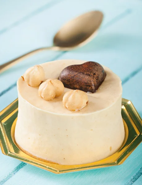 Small cake with hazelnuts and chocolate heart. — Stock Photo, Image