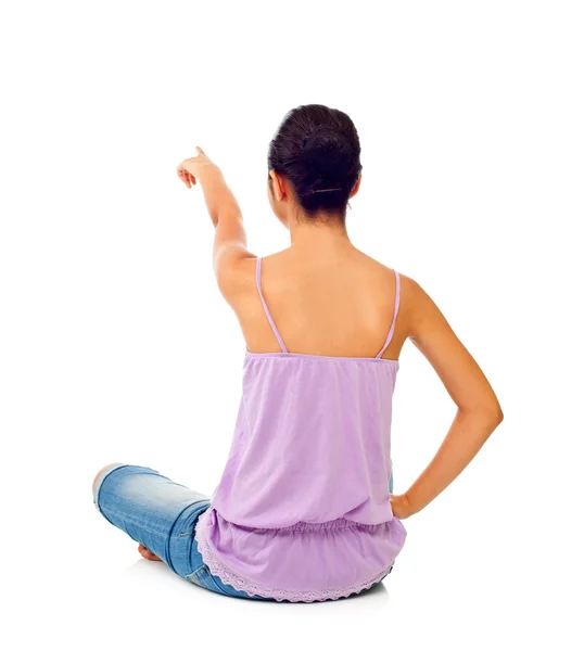 Seduta teen ragazza mentre punta con il dito — Foto Stock