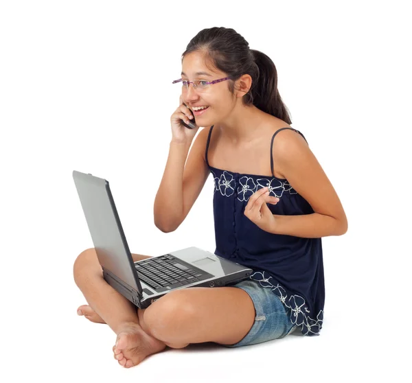 Teenager while talking on the phone with the laptop. — Stock Photo, Image