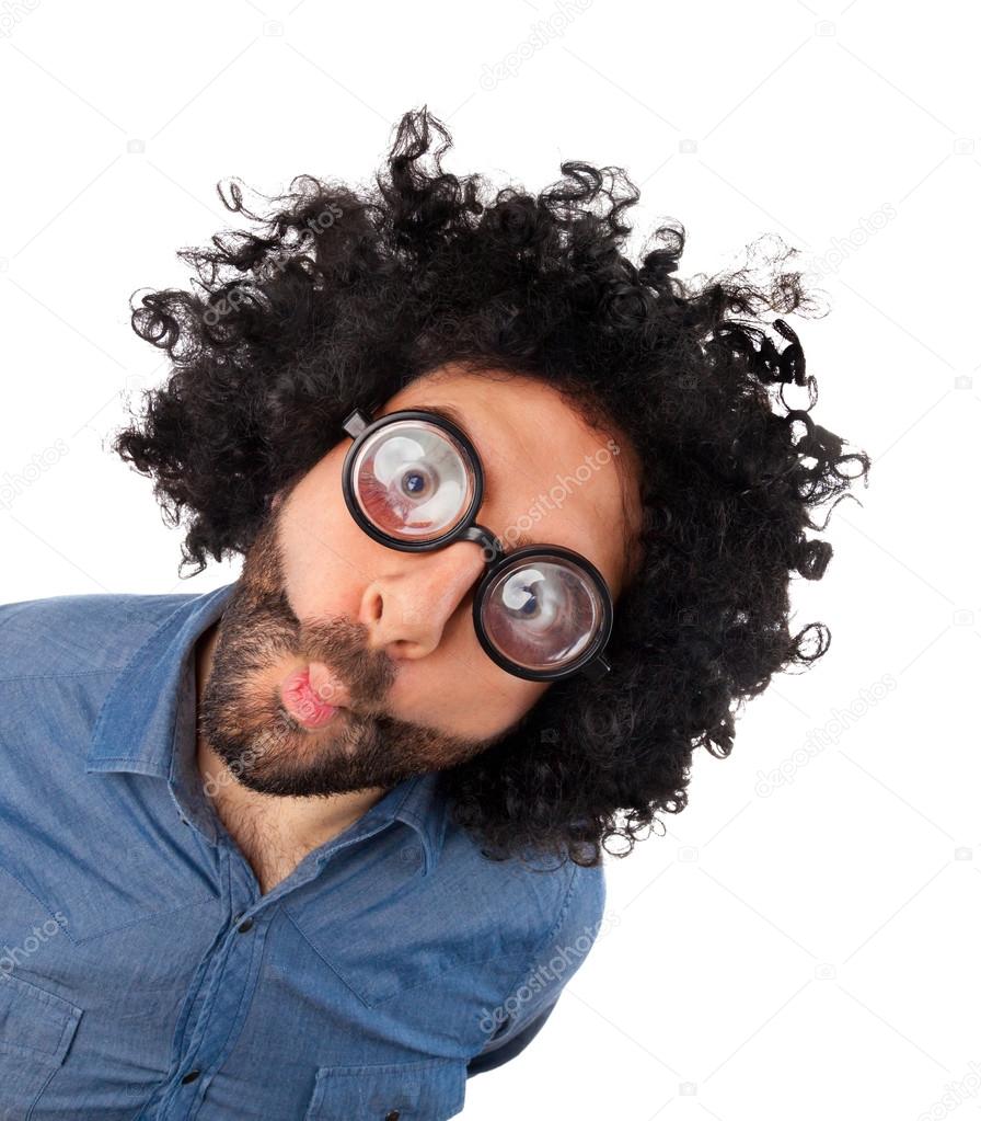 Funny young man with unkempt hair and thick glasses.