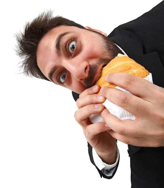 Junger Mann isst schnell ein Sandwich — Stockfoto