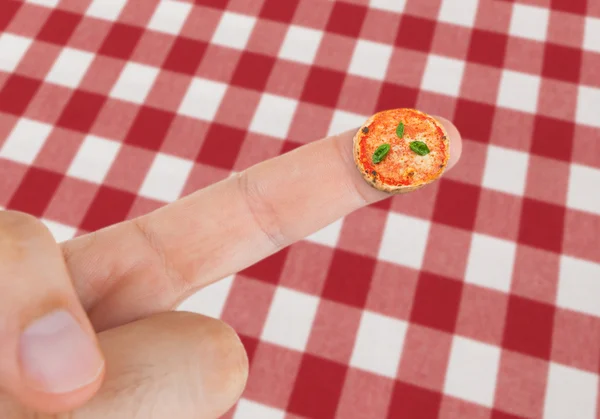 Dish with Pizza margherita in miniature on the finger — Stock Photo, Image