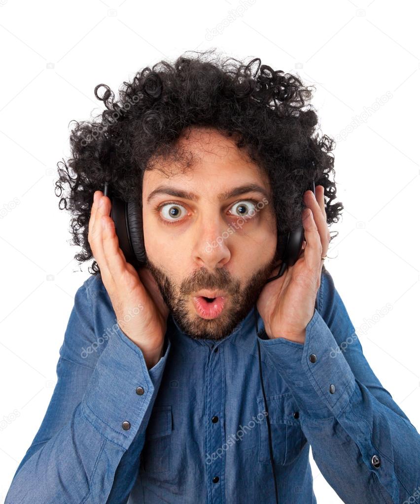 Young surprised man with headphones