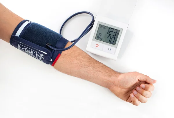 Hand with blood pressure equipment Royalty Free Stock Photos
