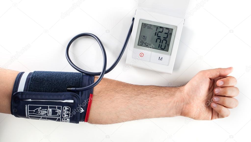 hand with blood pressure equipment