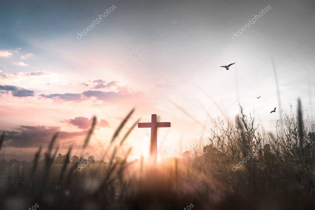 Easter concept: Silhouette cross on mountain at sunset background
