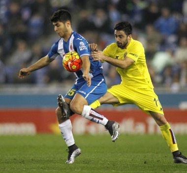 Marco Asensio of RCD Espanyol fights with Jaume Costa of Villareal CF clipart