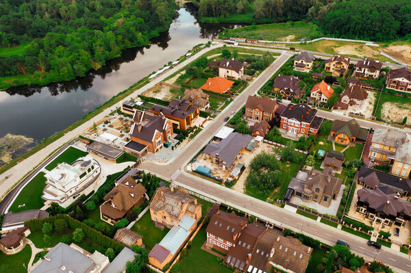 Construction of a cottage village on the river bank - aerial shot