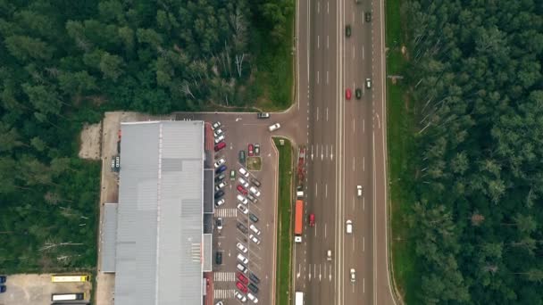 Tráfego na estrada perto do supermercado fora da cidade - o tilt-up revelar tiro — Vídeo de Stock