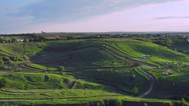 Jaki sport lubisz najbardziej? racing dirt track on the hills for car rally - aerial shot — Wideo stockowe