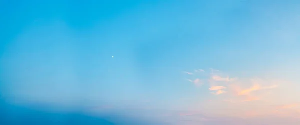 Blue clear sky with moon in the evening. Ozone layer of the planet.